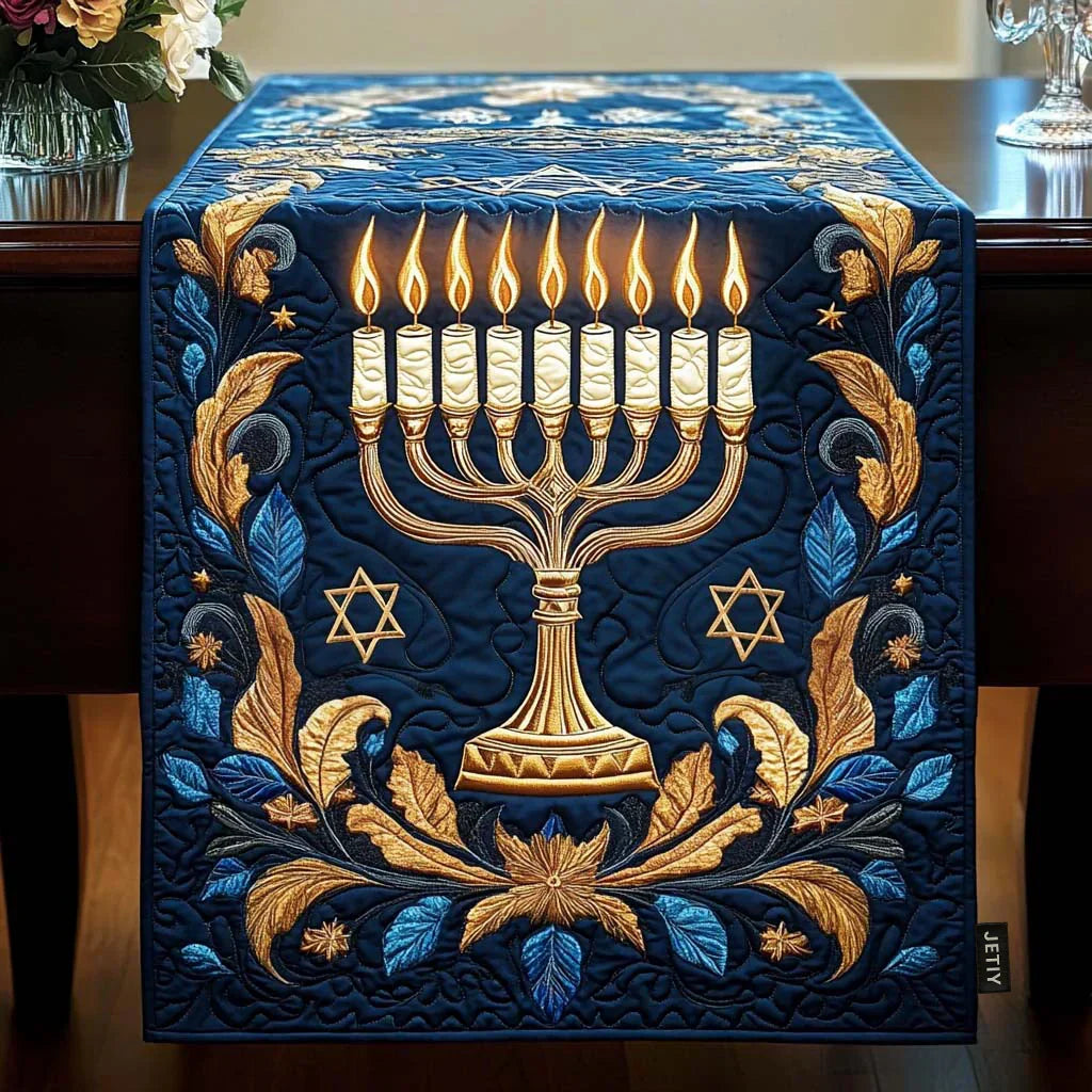 Quilted table runner with a lit golden menorah on a deep background laid down the centre of a table
