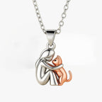 Silver-tone pendant of a woman hugging her cat