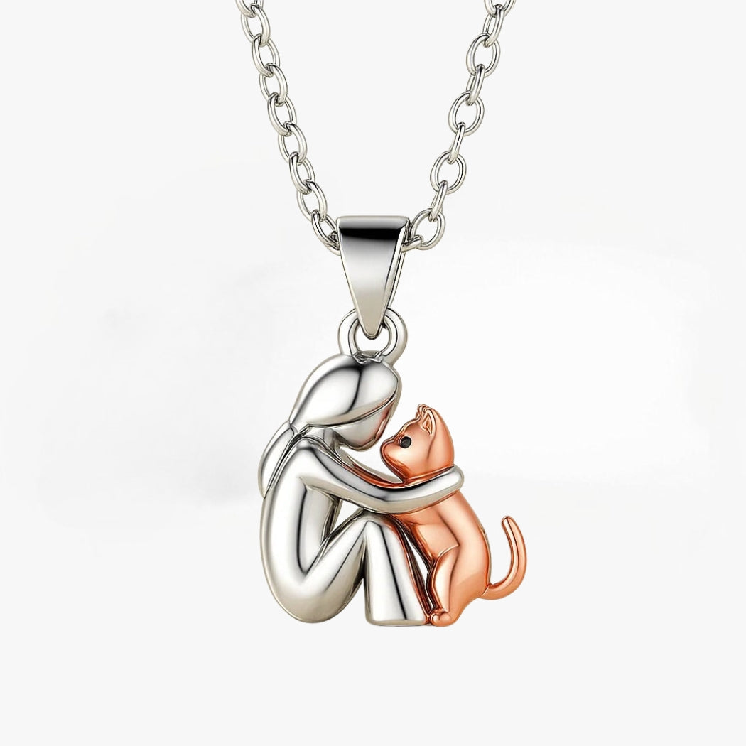 Silver-tone pendant of a woman hugging her cat