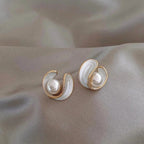 Faux pearl stud earrings in an opal-effect swirl edged in gold tone