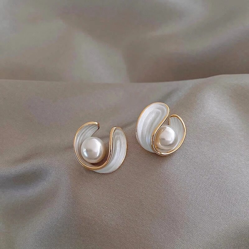 Faux pearl stud earrings in an opal-effect swirl edged in gold tone