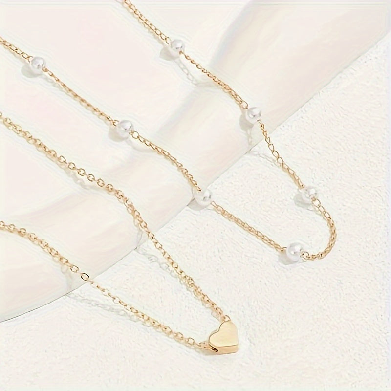 Gold-tone two-strand pearl and heart necklace with bracelet