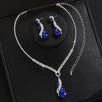 Silver-tone necklace and earrings set with a blue crystal teardrop