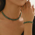 Green crystal leaf necklace and bracelet set in gold tone