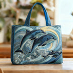 Artisan quilted tote bag with a dolphin leaping clear of curling waves under a pale open sky