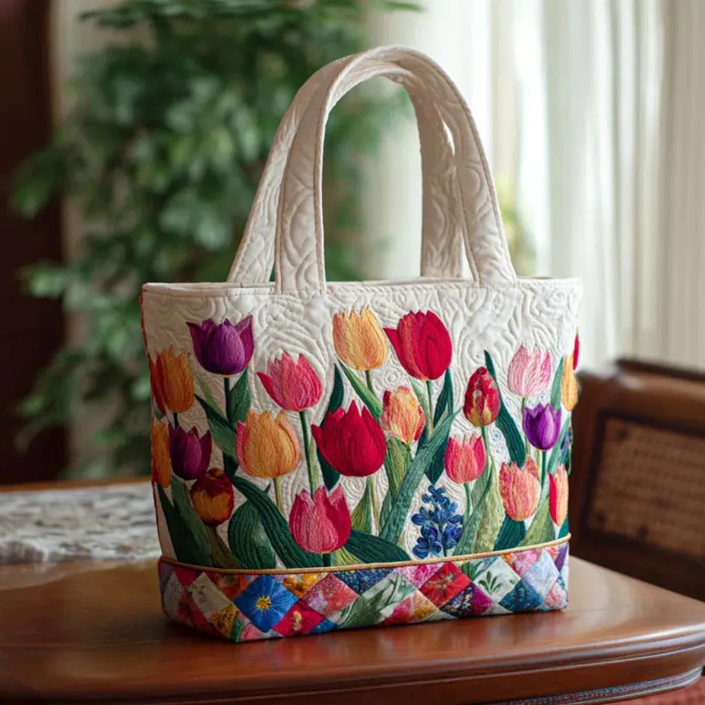 Artisan quilted tote bag with a Tulip Garden of red, pink and yellow tulips standing upright above deep green leaves