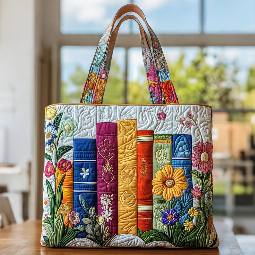 Artisan quilted tote bag with a row of book spines and flowers growing up and over them, petals resting between the pages