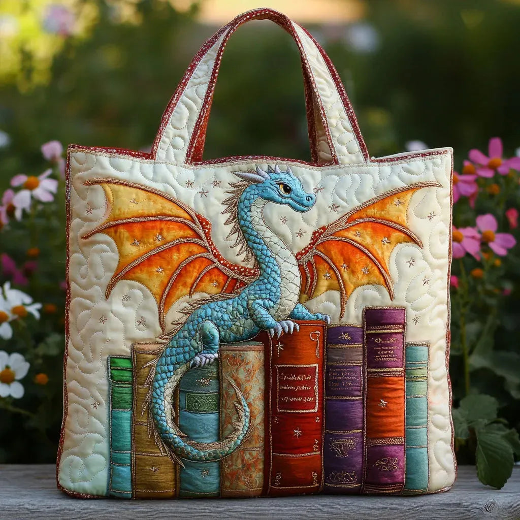 Artisan quilted tote bag with an emerald dragon curled around a stack of old books, scales in deep green and gold