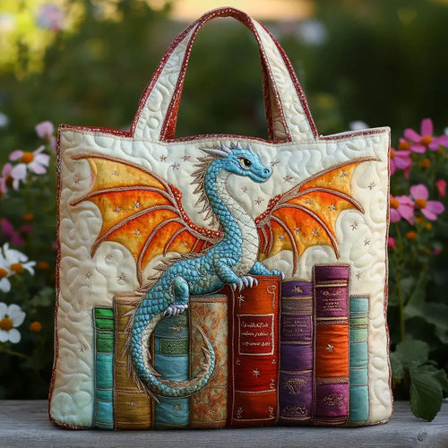 Artisan quilted tote bag with an emerald dragon curled around a stack of old books, scales in deep green and gold