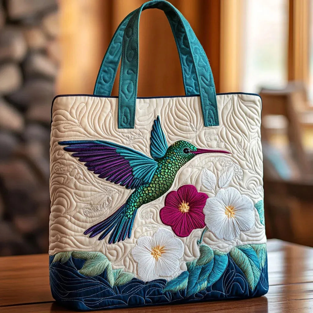 Artisan quilted tote bag with a hummingbird in green and blue hovering at a spray of white blossom