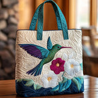 Artisan quilted tote bag with a hummingbird in green and blue hovering at a spray of white blossom