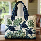 Artisan quilted tote bag with a single sea turtle gliding through drifting blue water and soft coral shapes