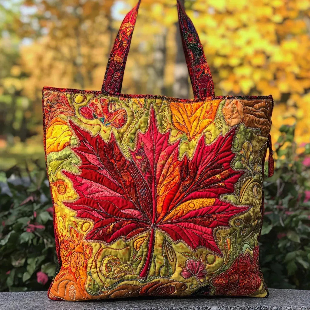 Artisan quilted tote bag with a maple tree in full autumn colour, leaves in red, amber and burnt orange against a low sun