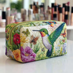 Bloom Dance quilted make-up bag with emerald hummingbird feeding among pink and purple garden flowers