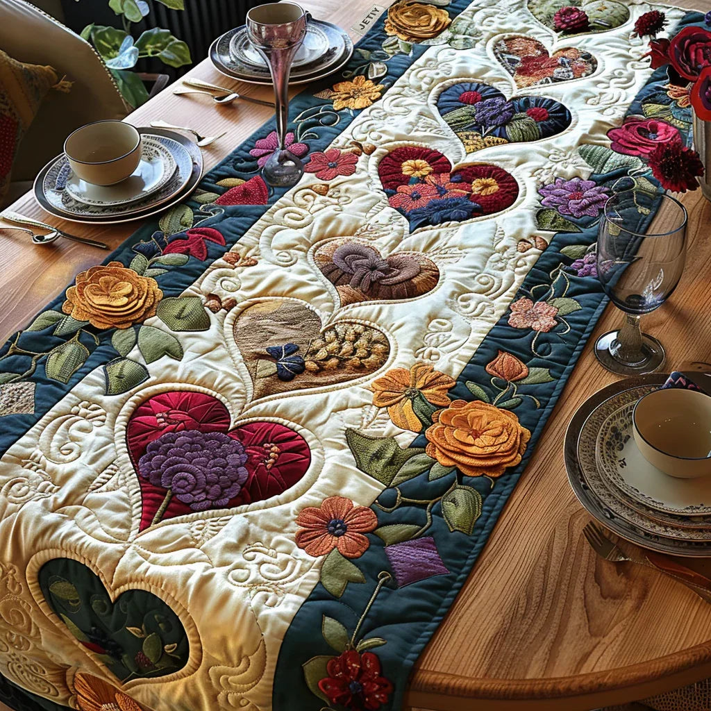 Quilted table runner with blossom-like hearts in dusky pink and cream laid down the centre of a wooden table