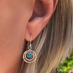 Drop earrings with a turquoise-blue stone in layered rings