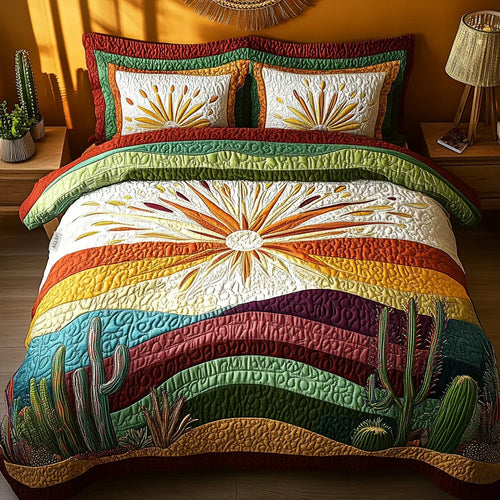 Quilted bedspread set with cacti in silhouette against a burnt orange and magenta evening sky, the Cactus Sunset design