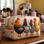 Chicken Comfort quilted make-up bag with hens in black-and-white stripes and polka dots beside a ginger hen, on cream