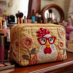 Chicken Shine quilted make-up bag with cheerful hen wearing red spectacles among garden flowers on mustard