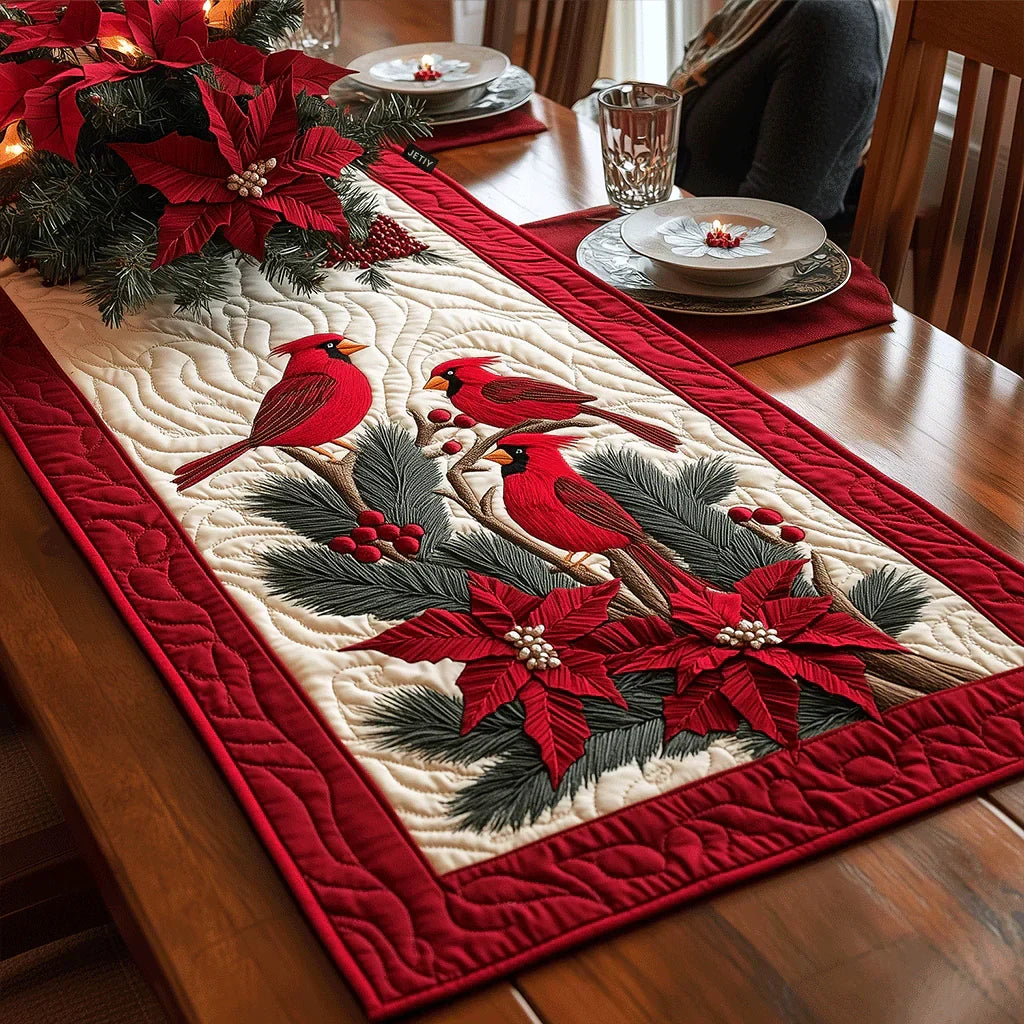 Quilted table runner with scarlet birds perched among berried branches on a pale ground
