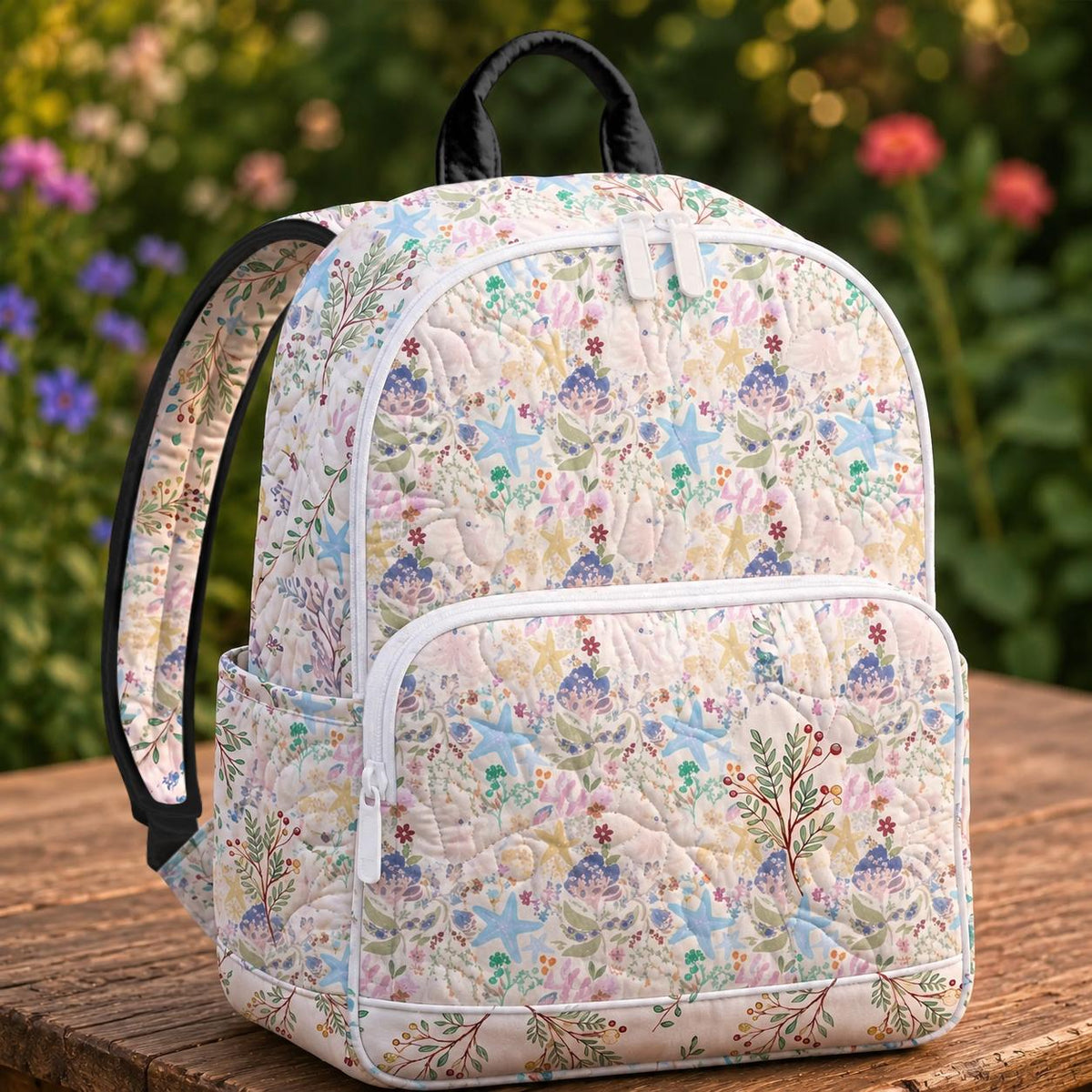 Artisan quilted backpack with starfish, shells and gentle waves in soft seaside pastel blues and pinks