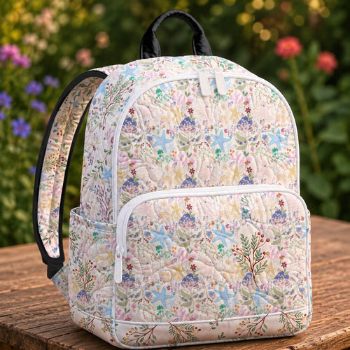 Artisan quilted backpack with starfish, shells and gentle waves in soft seaside pastel blues and pinks