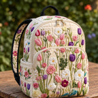 Artisan quilted backpack with a meadow of wildflowers and open blooms in soft summer colours