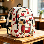 Artisan quilted backpack with a dachshund amongst red hearts and small flowers across the quilted front panel