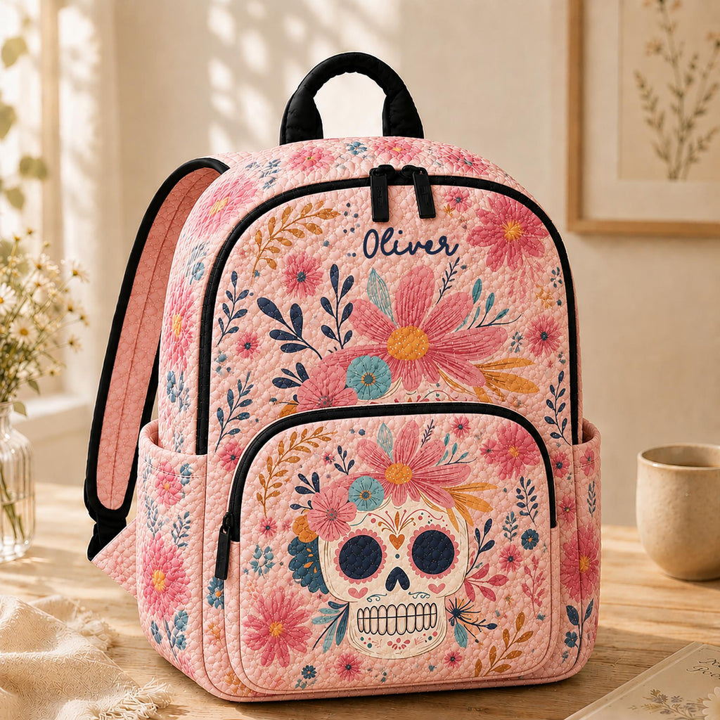 Artisan quilted backpack with a decorated sugar skull ringed by a garland of painted flowers and scrollwork