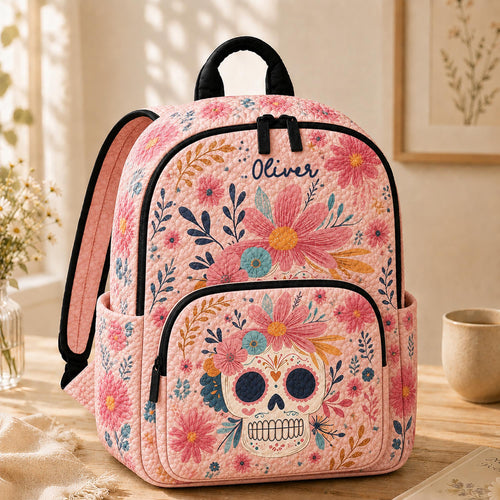 Artisan quilted backpack with a decorated sugar skull ringed by a garland of painted flowers and scrollwork