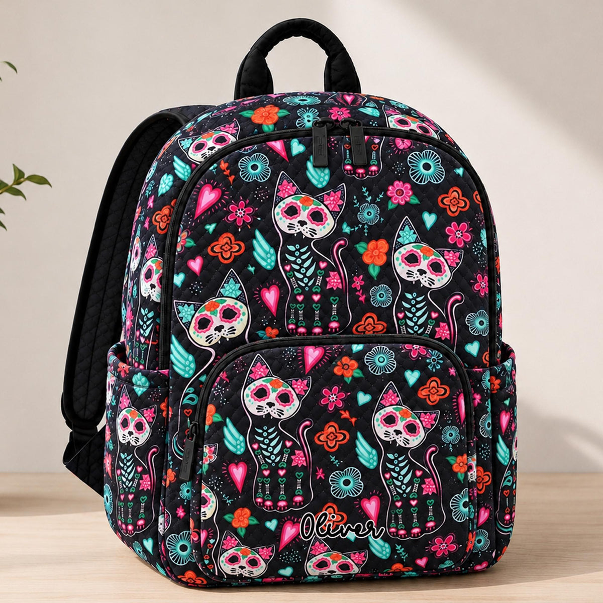 Artisan quilted backpack with a Day of the Dead cat, its face marked out in flowers, swirls and patterns