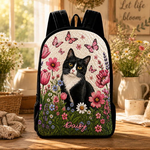 Artisan quilted backpack with a black cat sitting amongst white daisies in clean, simple printed shapes