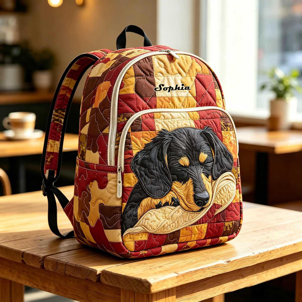Artisan quilted backpack with a dachshund stretched out in chestnut and black on a quiet ground