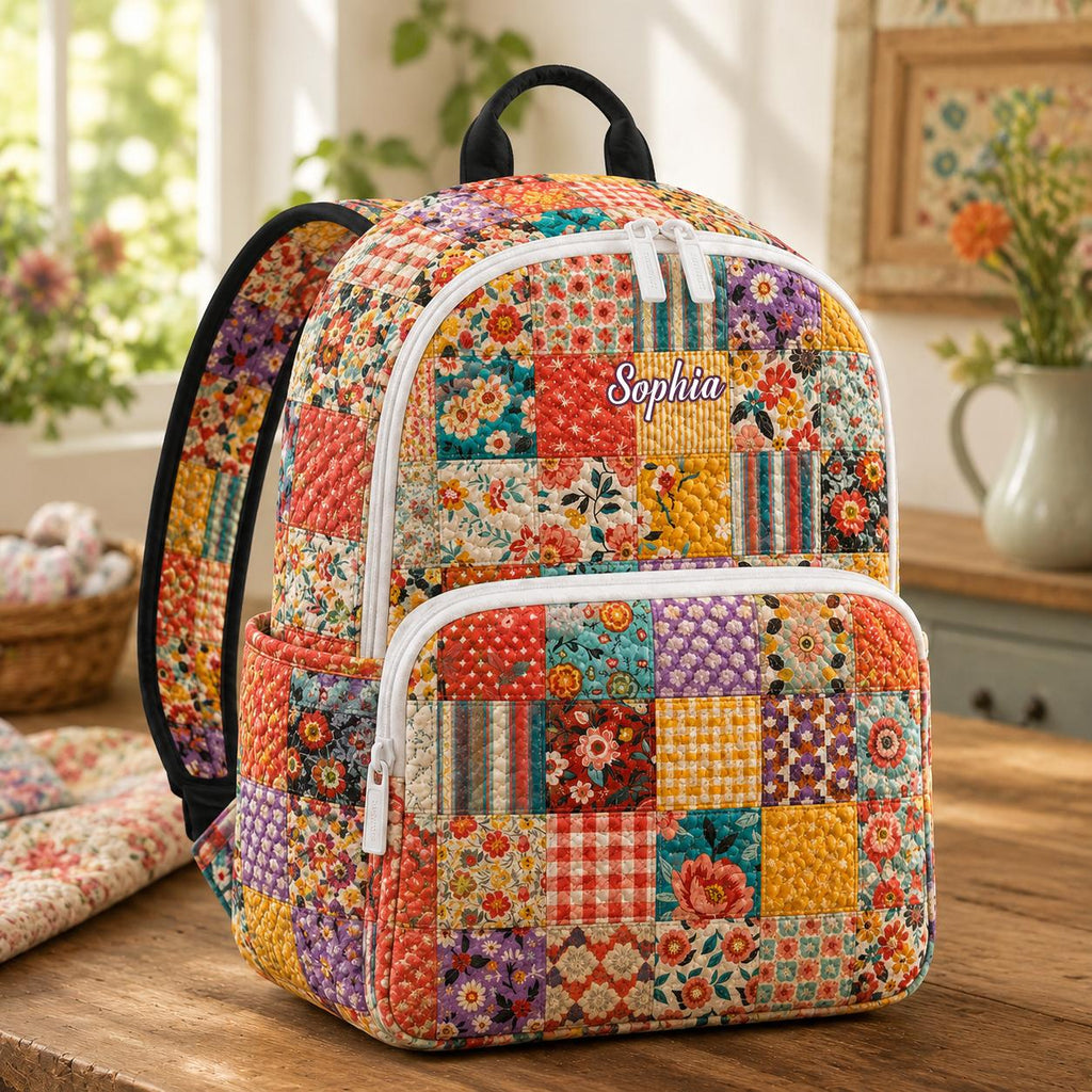 Artisan quilted backpack with a cottage style floral patchwork design in soft faded country colours