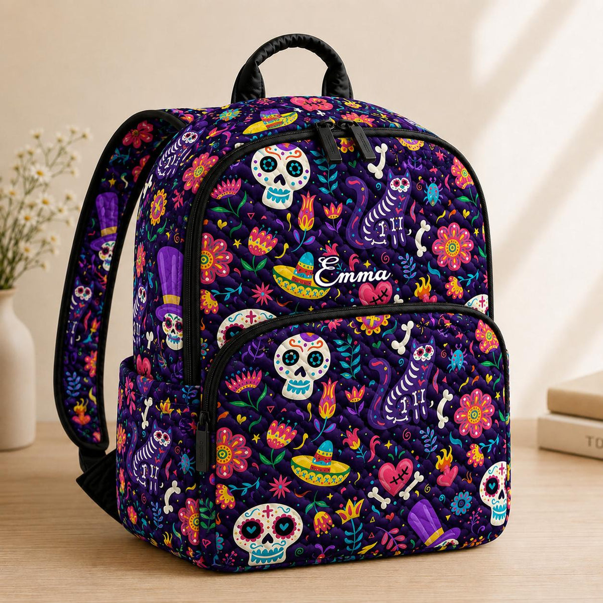 Artisan quilted backpack with colourful Day of the Dead skulls set amongst big open painted flowers