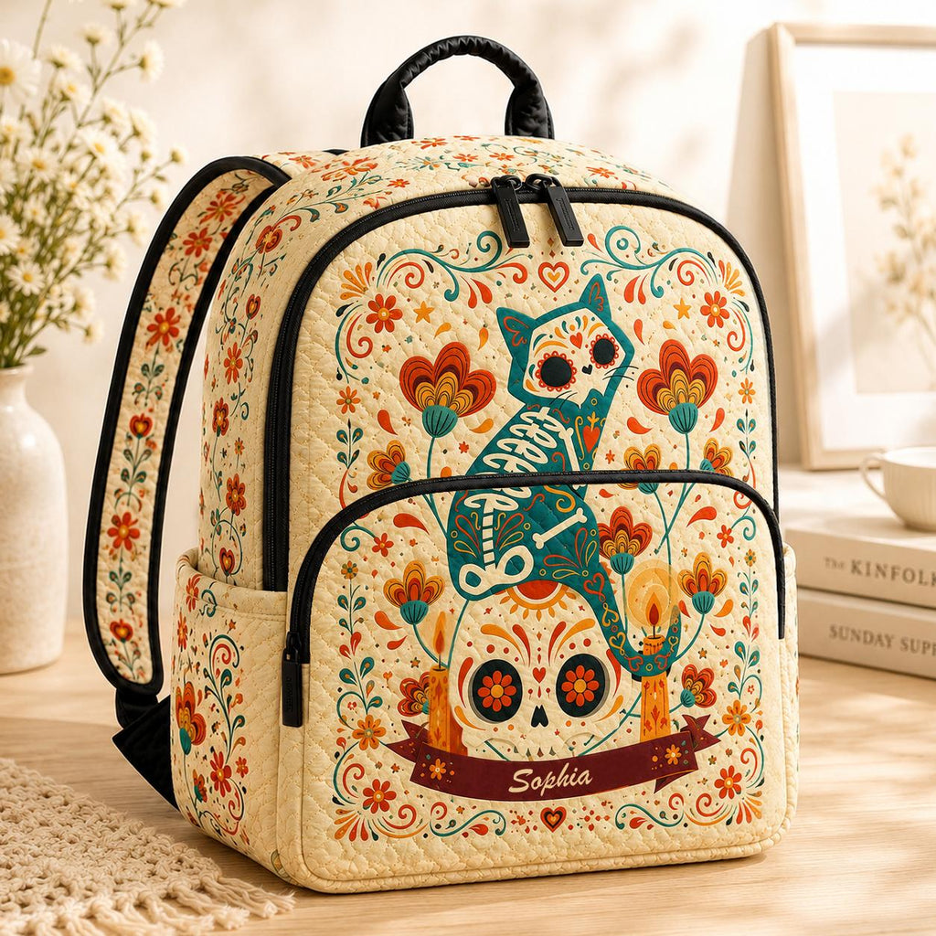 Artisan quilted backpack with a sugar skull cat design in bright folk-art swirls, blooms and dots