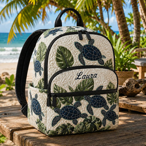 Artisan quilted backpack with sea turtles swimming through deep blue water