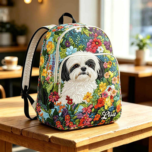 Artisan quilted backpack with a shih tzu looking out, its face framed by soft flowers and leaves