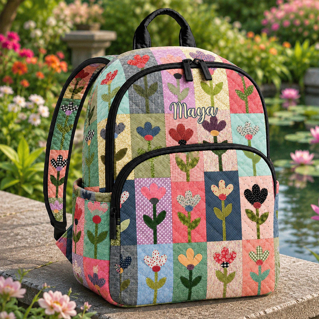 Artisan quilted backpack with floral patchwork squares pieced together in an assortment of flowered prints