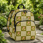 Artisan quilted backpack with white daisies scattered across green patchwork squares in mixed floral prints