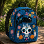 Artisan quilted backpack with sugar skulls amongst blue flowers and fine white scrollwork on quilted fabric