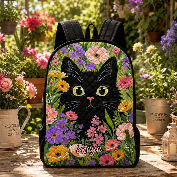Artisan quilted backpack with a black cat amongst soft blossoms, finished with plain black straps