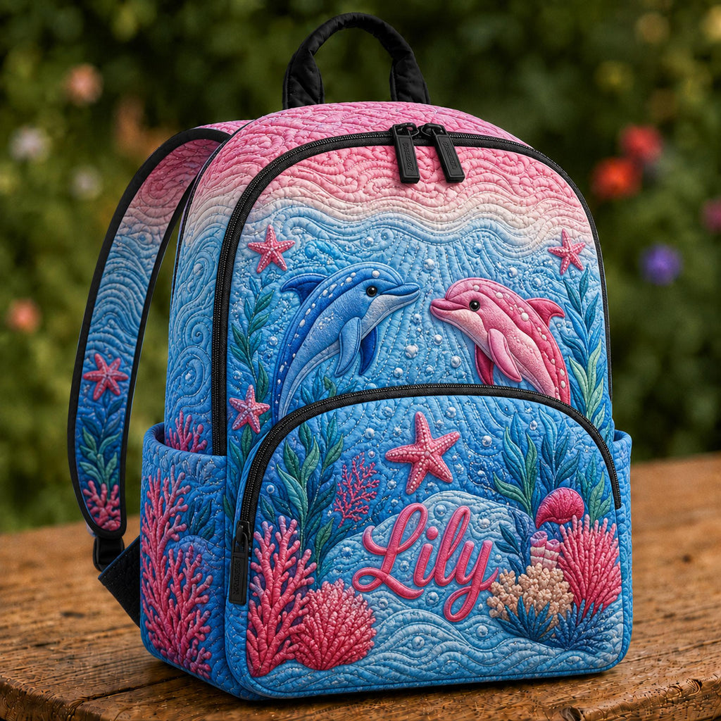 Artisan quilted backpack with dolphins arcing through open blue water in ocean blues and greys