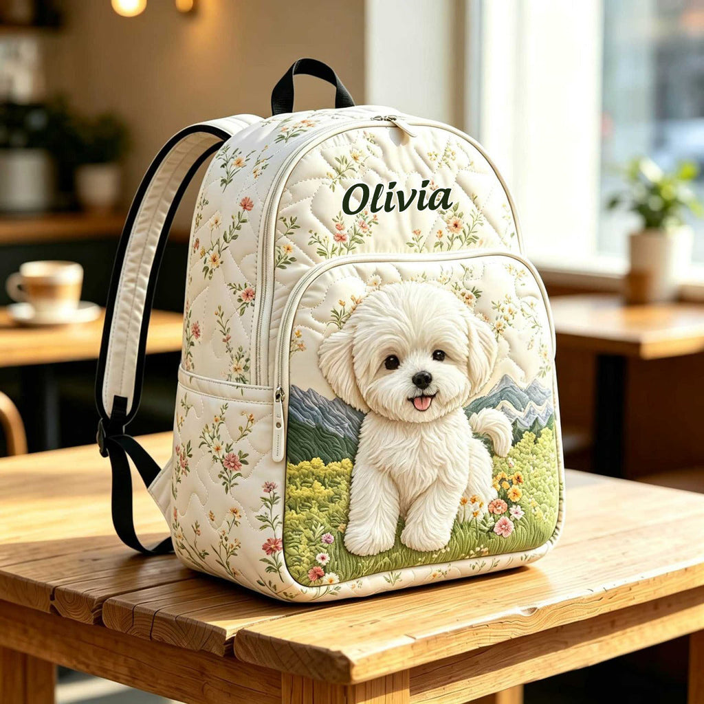 Artisan quilted backpack with a puppy sitting amongst soft painted blooms across the quilted front panel