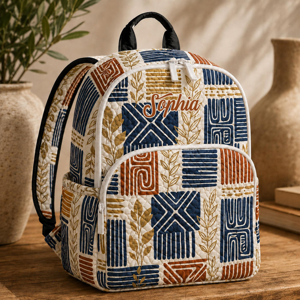 Artisan quilted backpack with a bohemian tribal pattern of repeating geometric bands in warm earthy tones
