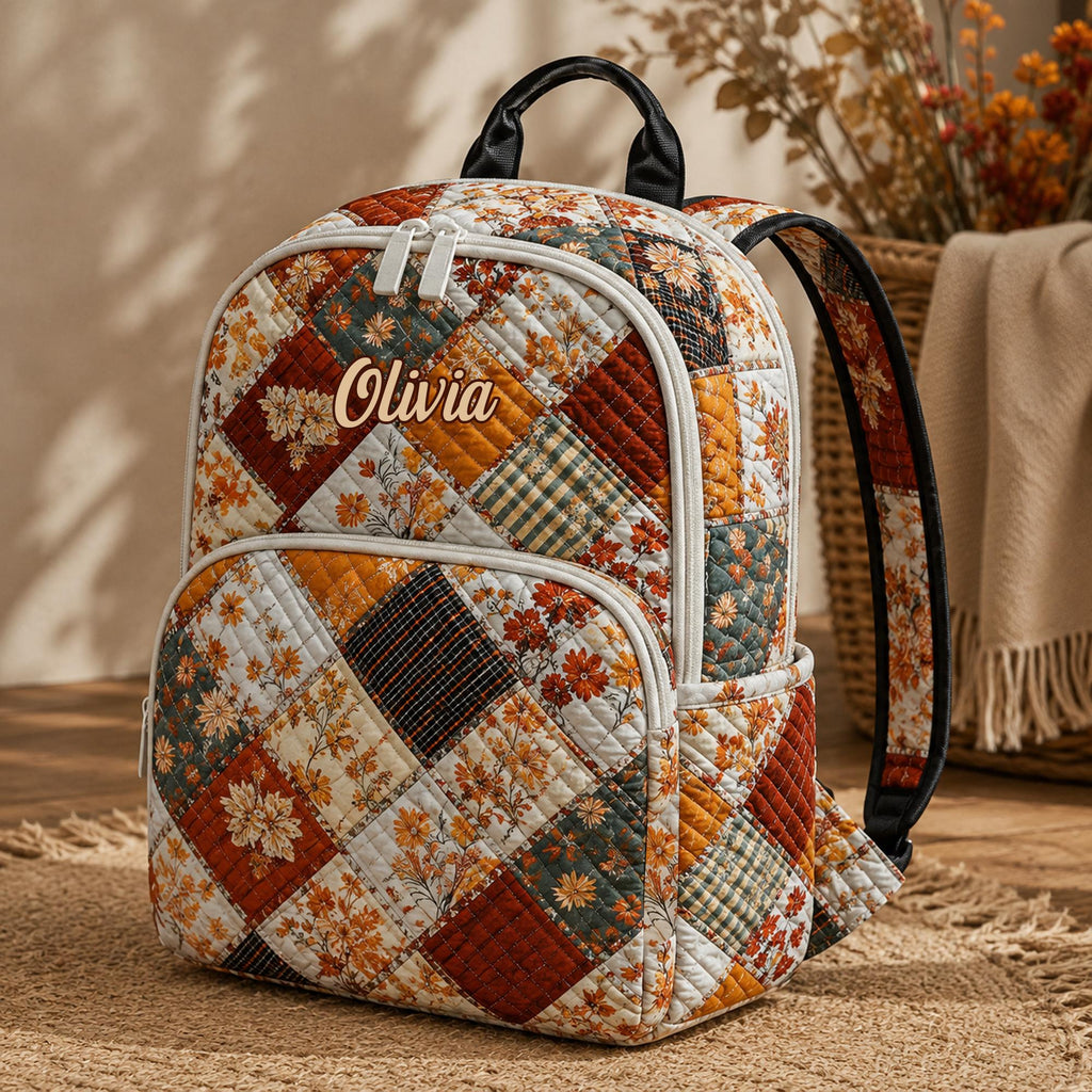 Artisan quilted backpack with a soft coquette floral design of small flowers scattered on a pale ground