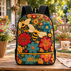 Artisan quilted backpack with bees moving amongst a scattered meadow of wildflowers and green foliage