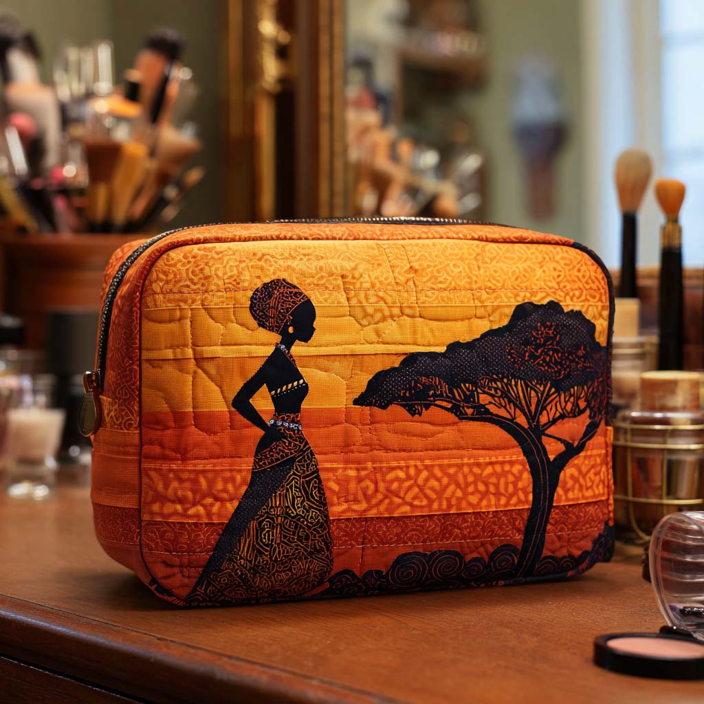 Desert Muse quilted make-up bag with woman and an acacia tree in silhouette against an orange sunset