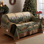 Mountain Retreat quilted sofa cover with snow-topped mountains behind a pine forest in sage, olive and soft grey