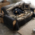 Bear Cave Shadows quilted sofa cover – black bear in a grey cave